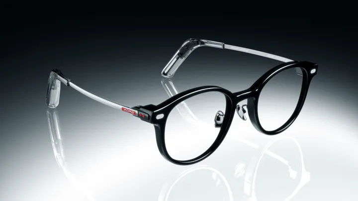 The NIMO frame in three-quarter profile with clear 1.74 prescription lenses seated in the round black rims